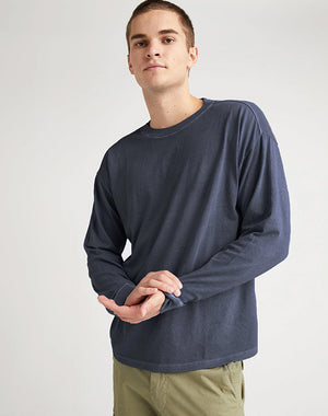 Model in Men's Relaxed Long Sleeve Tee in Blue Steel (Blue) | Richer Poorer